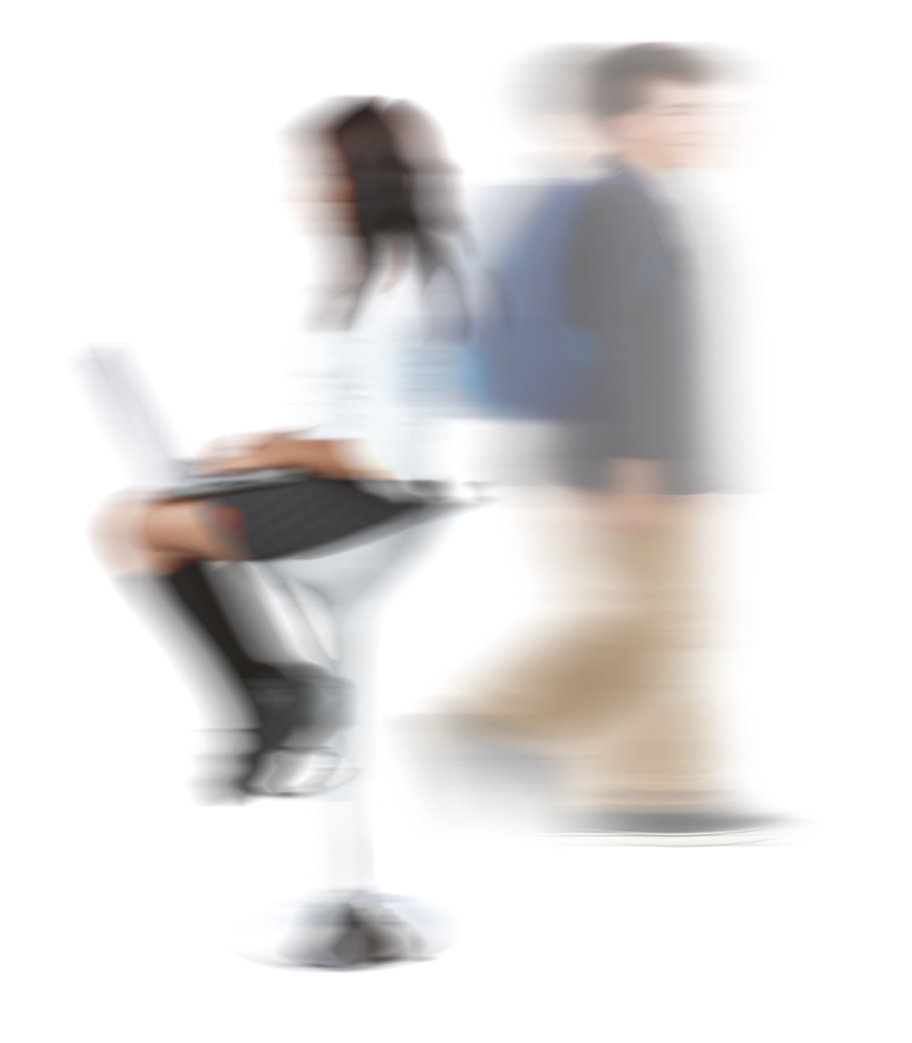 Blurred image of a man walking past woman sitting down with a laptop